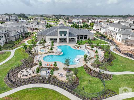 A large building with a pool in front of it.