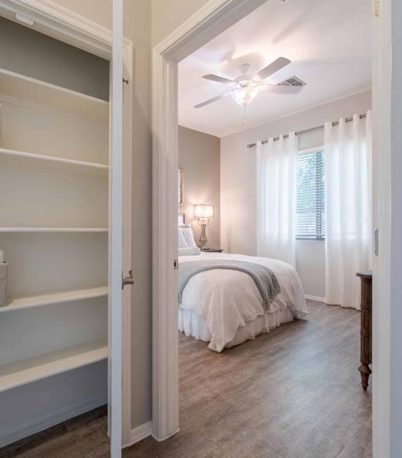Bedroom with built in storage shelving at Vistoria On Greenway Apartments, Surprise, AZ