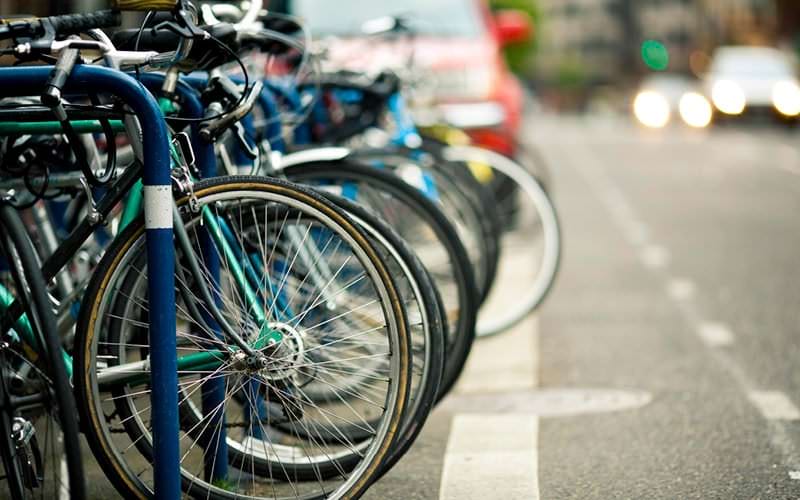 parked bicycles lined up along city street