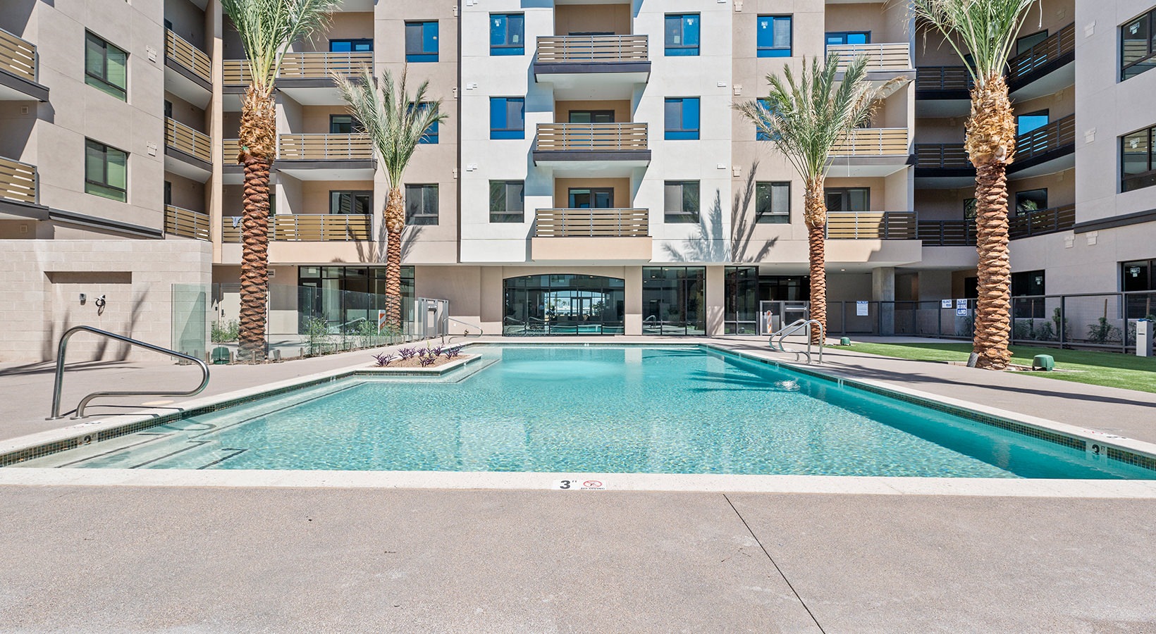 Dog-Friendly Luxury Apartments In Old Town Scottsdale, AZ - Formation - Swimming Pool, Lounge Areas, Palm Trees, Balcony, And Multi-Story Residential Building.