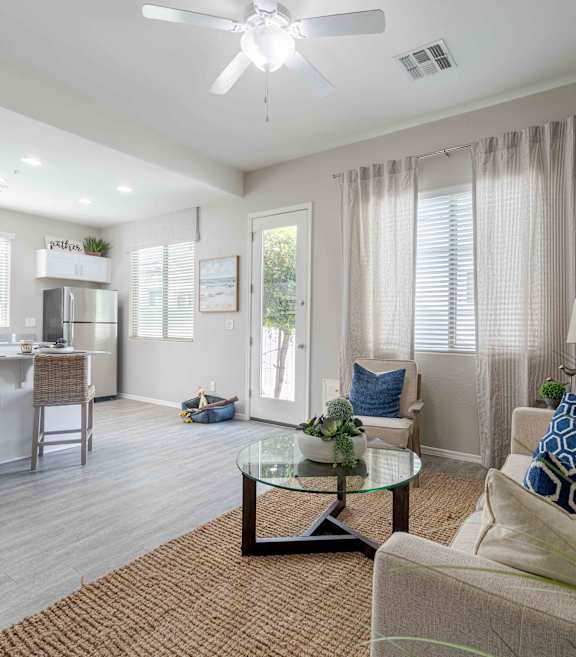 A bedroom with a bed, nightstand, and a plant at Vistoria At Country Place Apartments, Tolleson, AZ, 85353