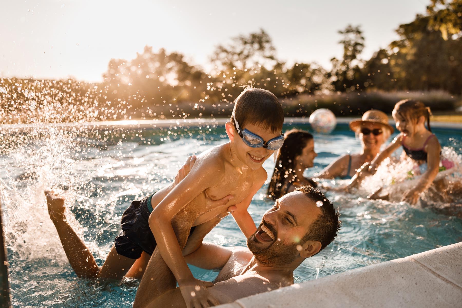 Father and son playing in the swimming pool