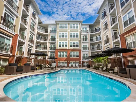Community pool surrounded by apartment buildings.