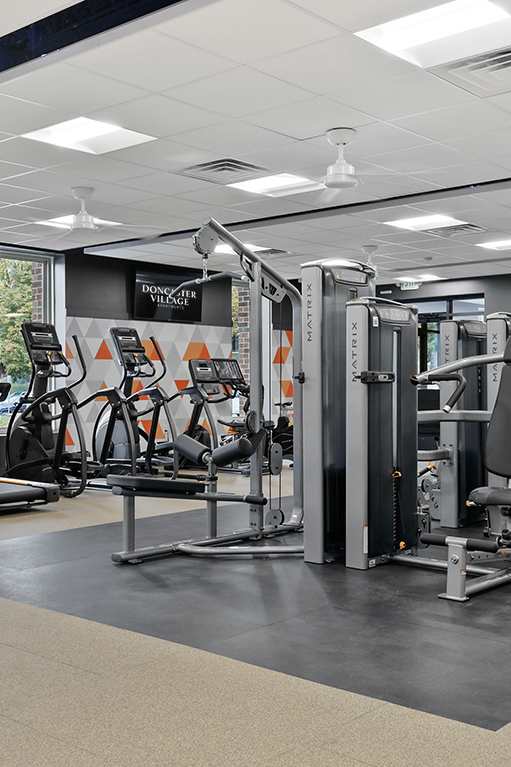 a workout room with treadmills and a tv at DonCaster Village Apartments, Parkville, MD, 21234