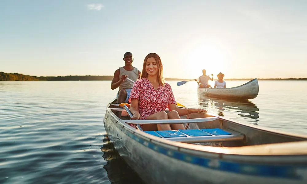 young adults kayaking in water