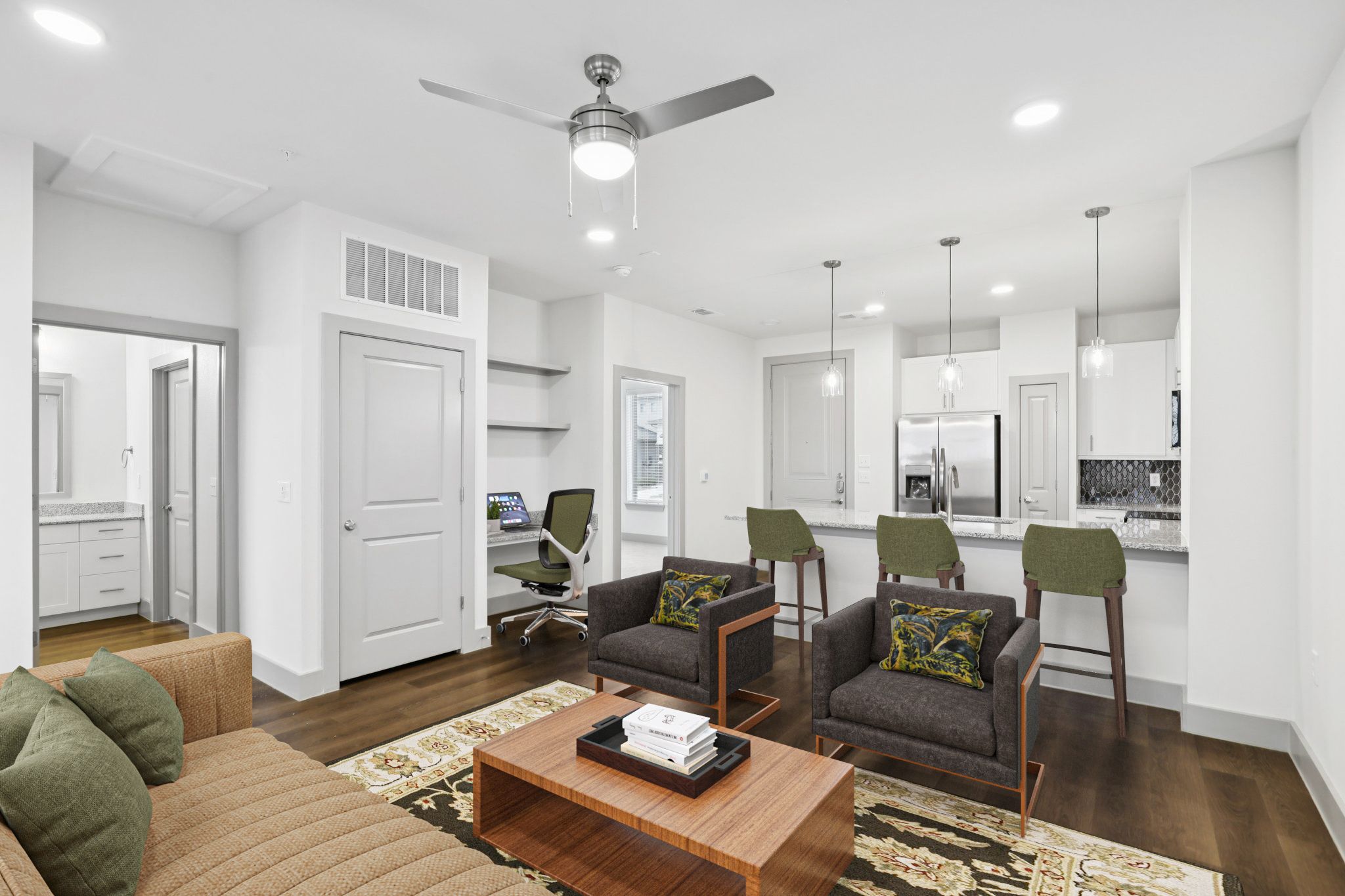 Modern living room with a sleek kitchen, stylish furniture, and a cozy atmosphere.