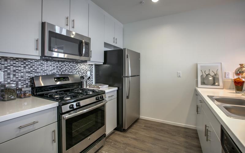 a kitchen with grey cabinets