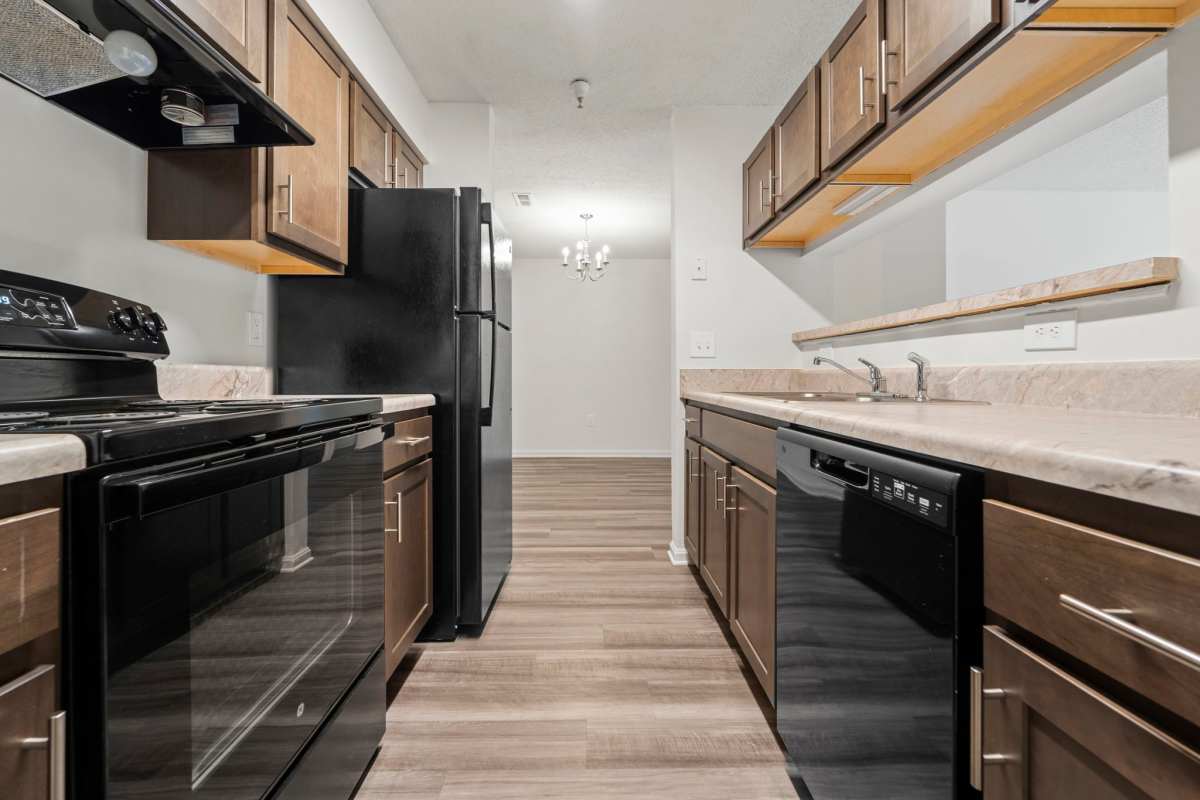 Kitchen with appliances at Dulles Center Apartments in Herndon, Virginia