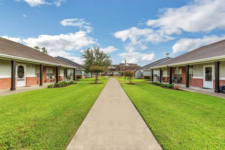 Stylish brick apartment building with plenty of green space at Humble Memorial Gardens