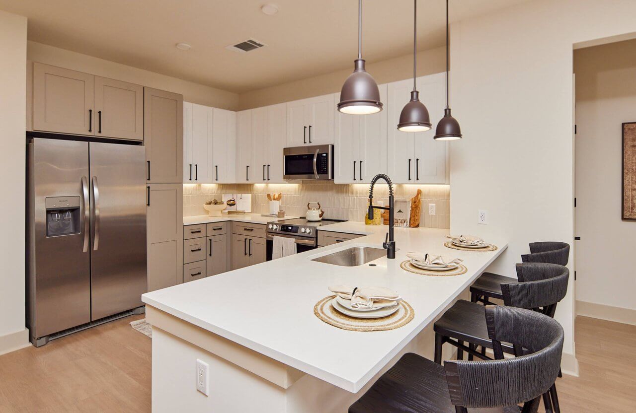 modern kitchen with quartz countertops in a Huntersville apartment at Merritt