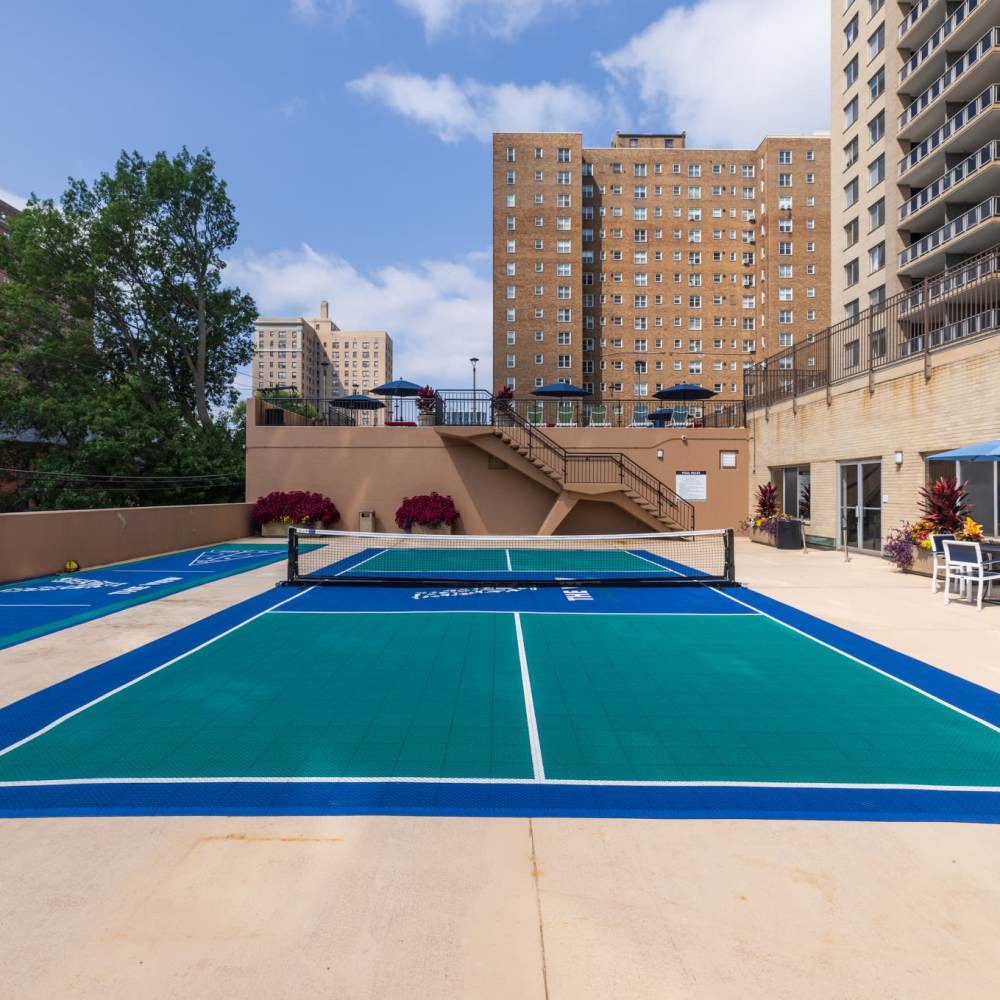 Pickle ball court surrounded by lush landscaping and inviting seating areas for relaxation at The View at Forest Park in St. Louis, Missouri
