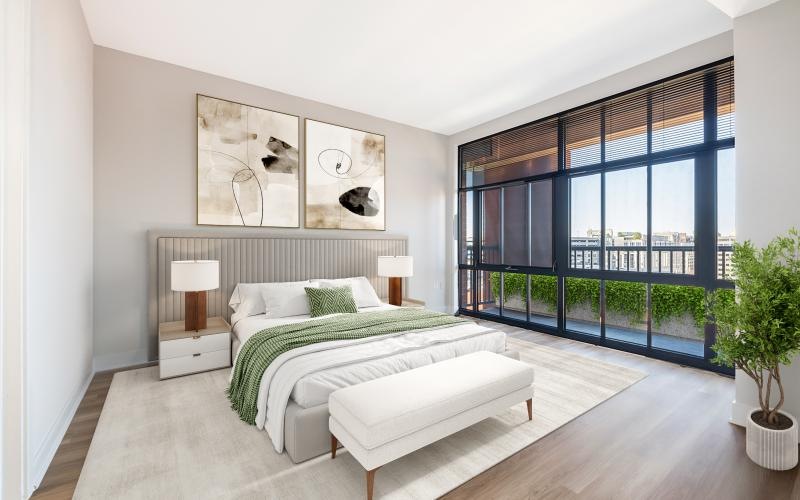 Model bedroom with large bed and large floor to ceiling window at Senate Square city view apartments in Washington, DC.