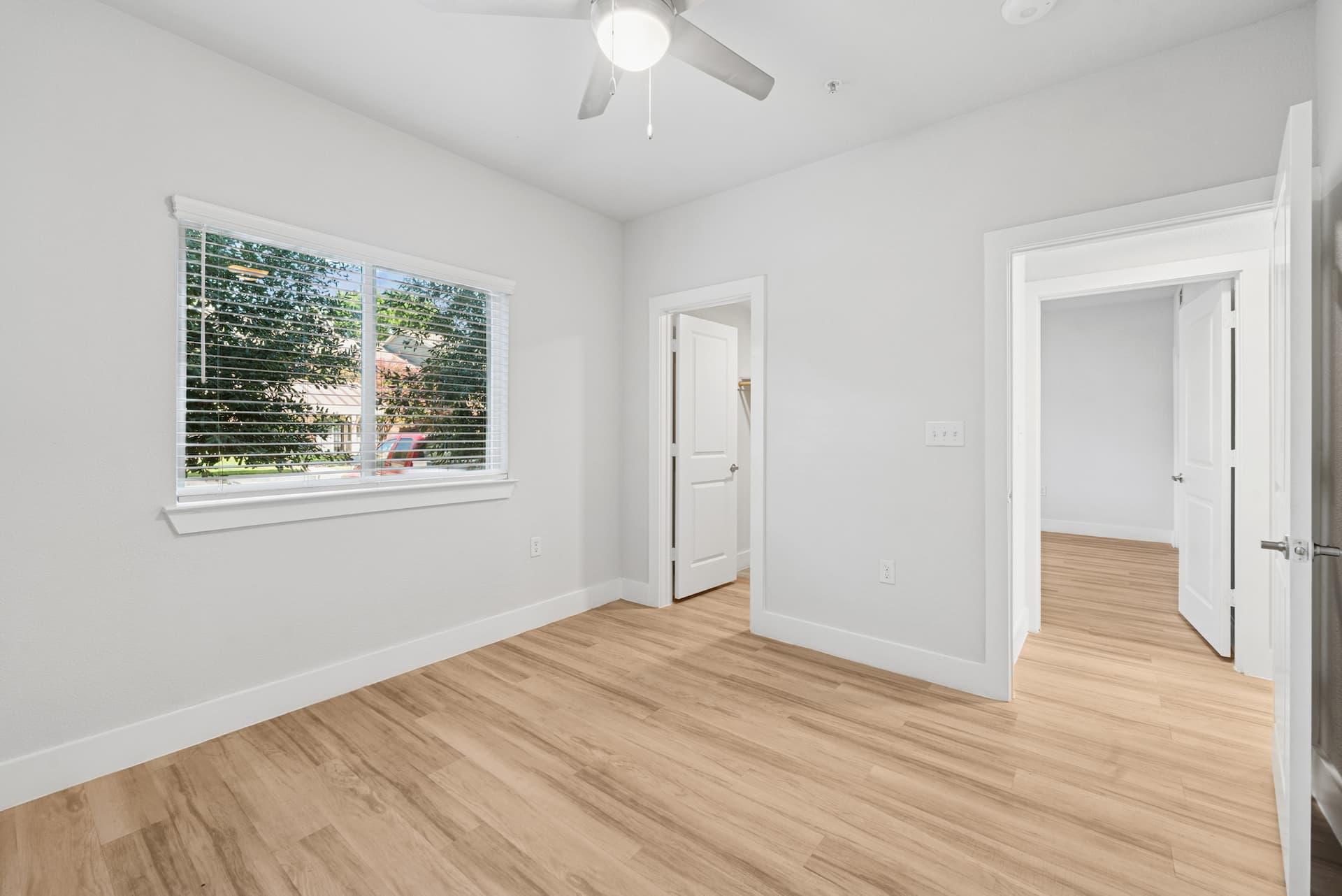 Open kitchen at Ensign Apartments featuring granite countertops and stainless steel appliances.