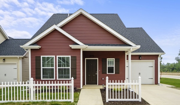 a red house with a driveway