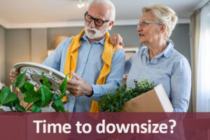 A senior man and woman sorting items in boxes in preparation of moving into a senior living community.