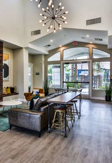 A living room with a fireplace and a dining table.