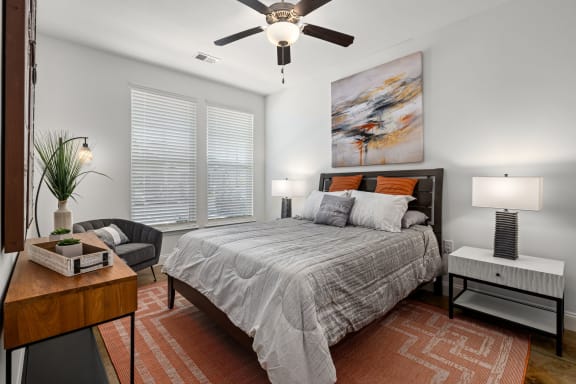a bedroom with a bed and a ceiling fan