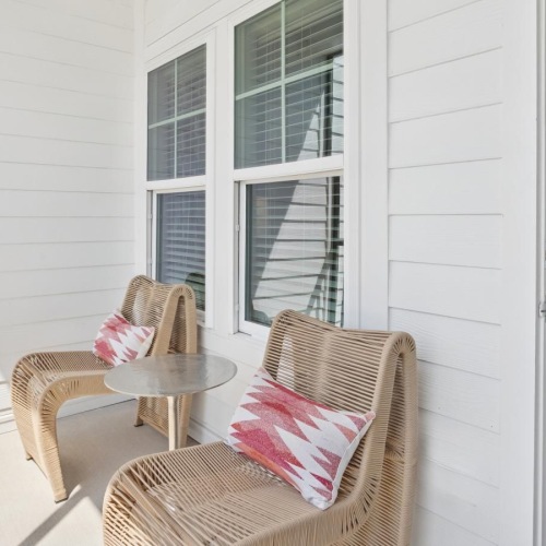 a patio area with chairs and a table