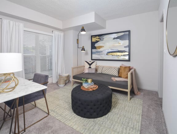 a living room with a couch and a table at The Citizen at Shirlington Village, Virginia