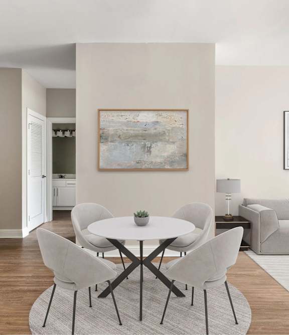 A modern dining room with a white table and chairs.