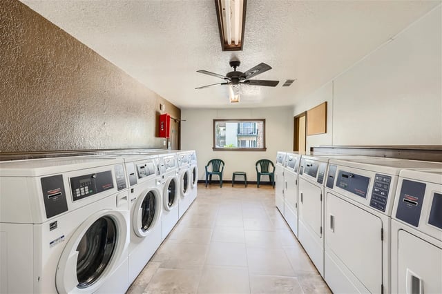 Laundry room with rows of washers and dryers