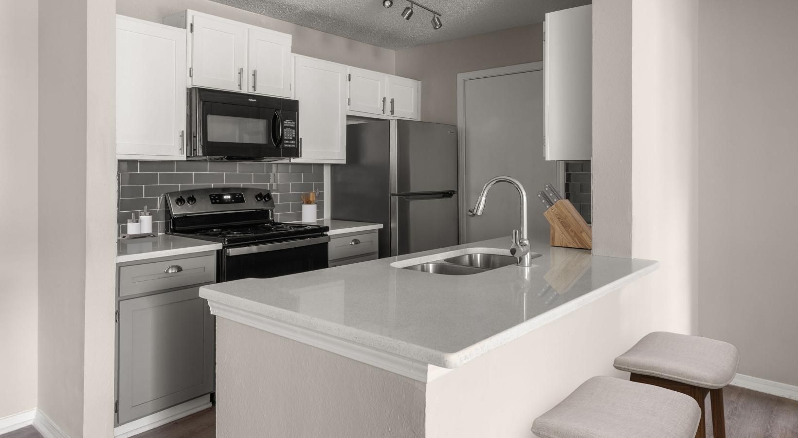 a kitchen with white cabinets
