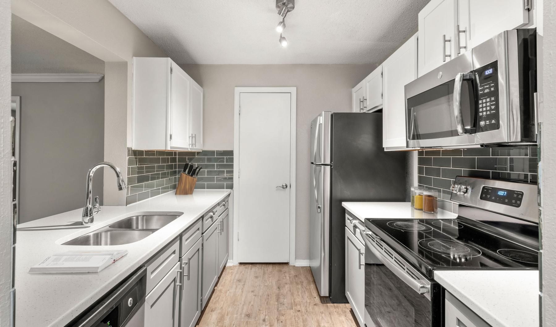 a kitchen with white cabinets