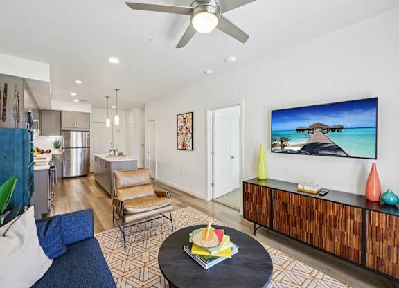 A living room with a flat screen TV on the wall.