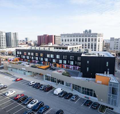 A parking lot with cars and a building in the background.