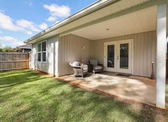 a patio in front of a house with a chair on it