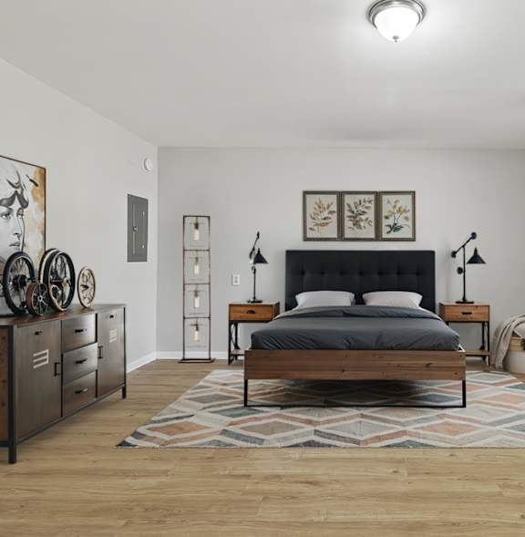 A bedroom with a bed, nightstands, and a rug.