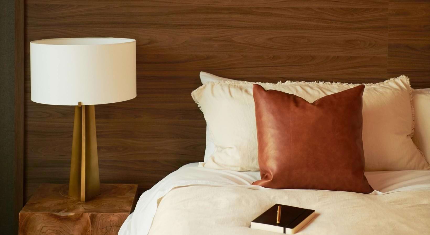 a bed with a lamp on it
