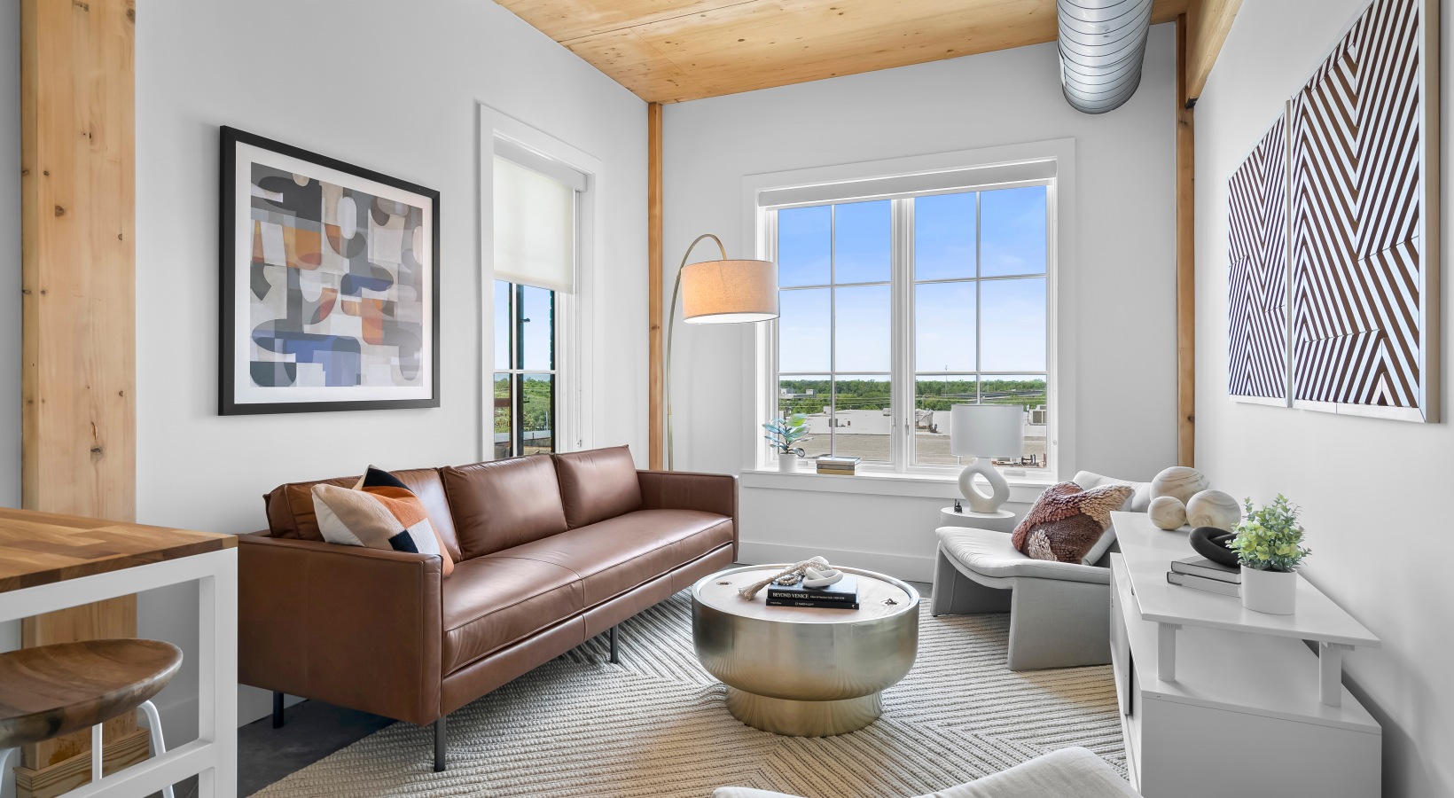living room with leather couch, table, console and side chair