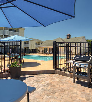 Pool adjacent grill and picnic area.