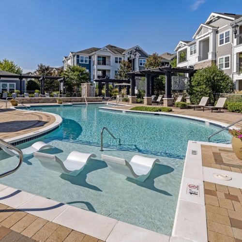 a swimming pool with lounge chairs