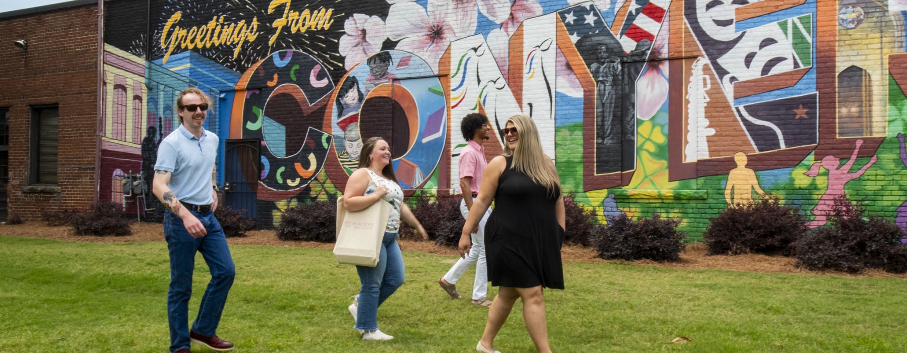 a group of people walking across a yard