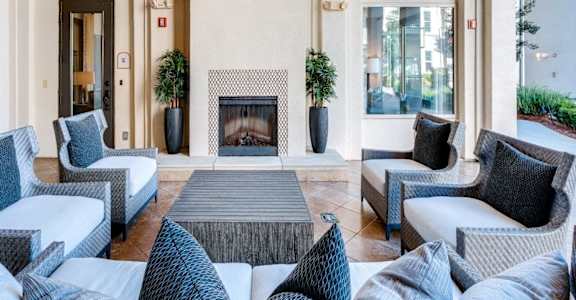 A living room with a fireplace and couches at Two Addison Place, Pooler, 31322