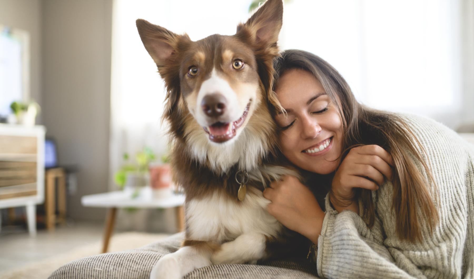 a woman hugging a dog