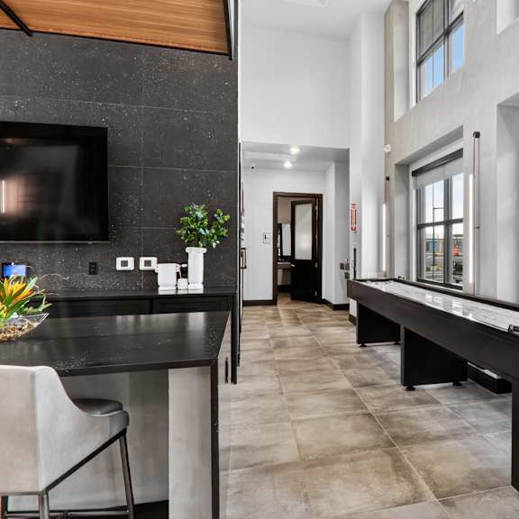 A patio with a table and chairs and a television.at The Logan Luxury Apartments, Nampa, ID, 83651