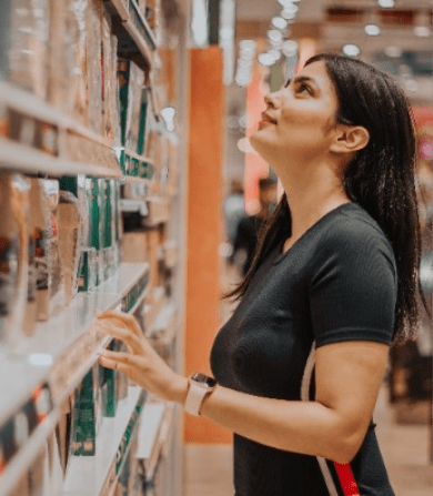 Lady checking out products in grocery store. Washington, DC is home to various local family-owned & high-end national brands.