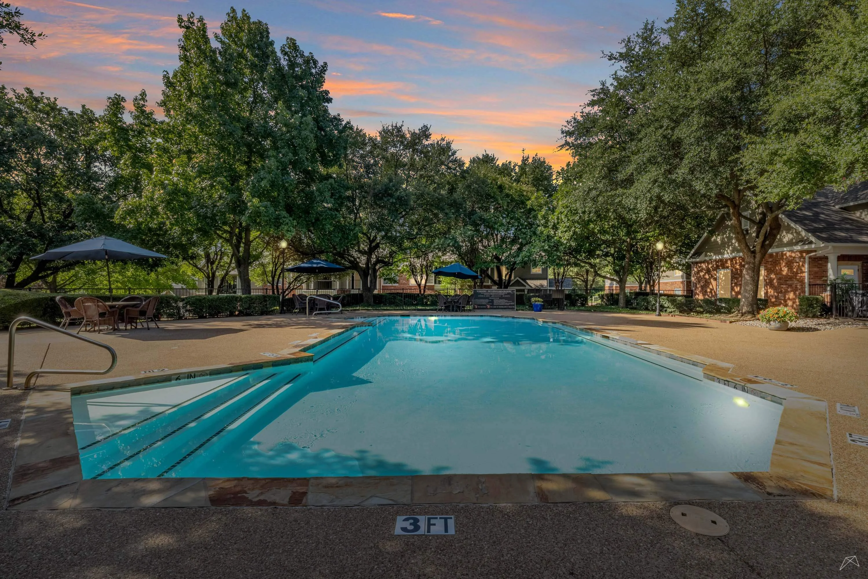 Residence at the Oaks apartment swimming pool at dusk
