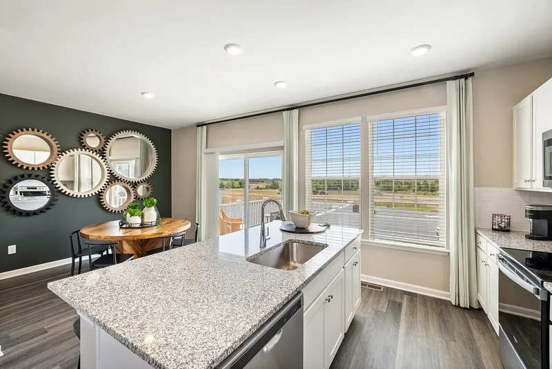 View of kitchen island and furnished dining room in background
