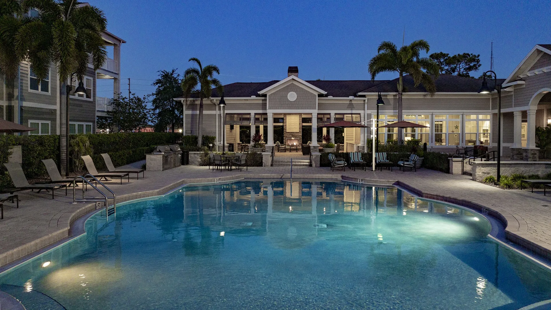 Swimming pool and sundeck with lounge chairs.