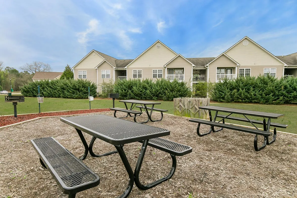 Picnic area with 3 metal picnic tables on mulched area