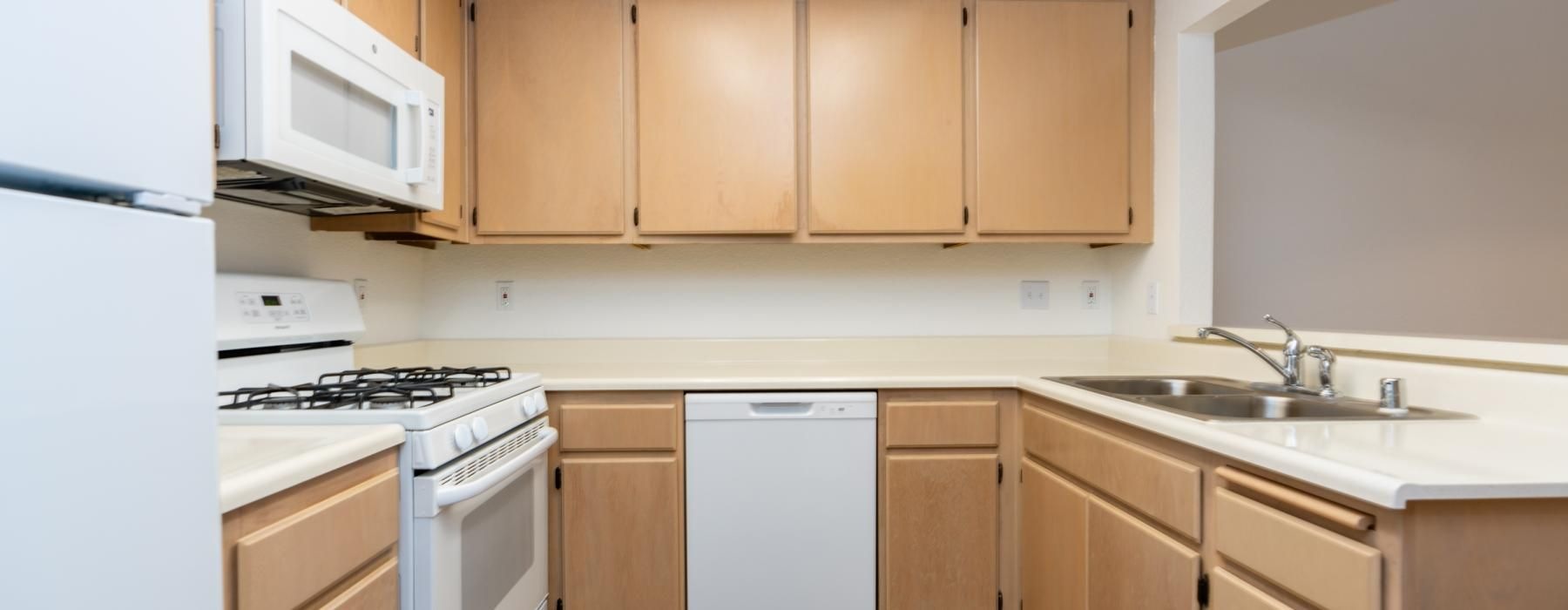 a kitchen with wooden cabinets