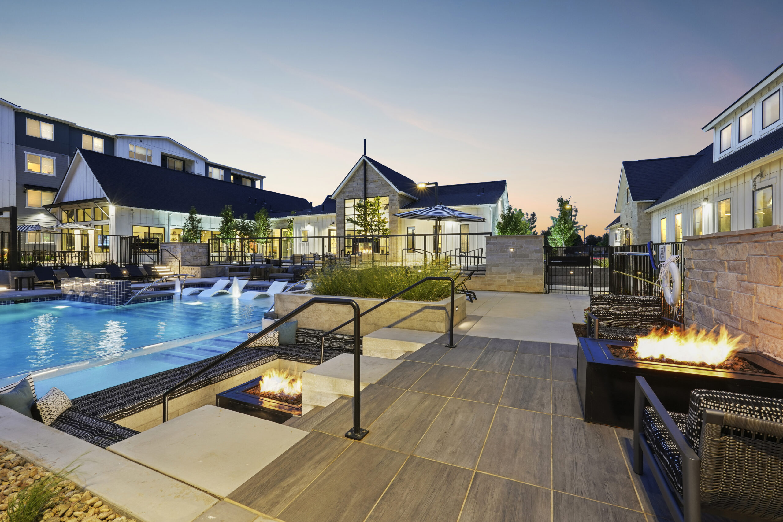 Resort-style pool with seating areas, firepits, and Clubhouse in the background.