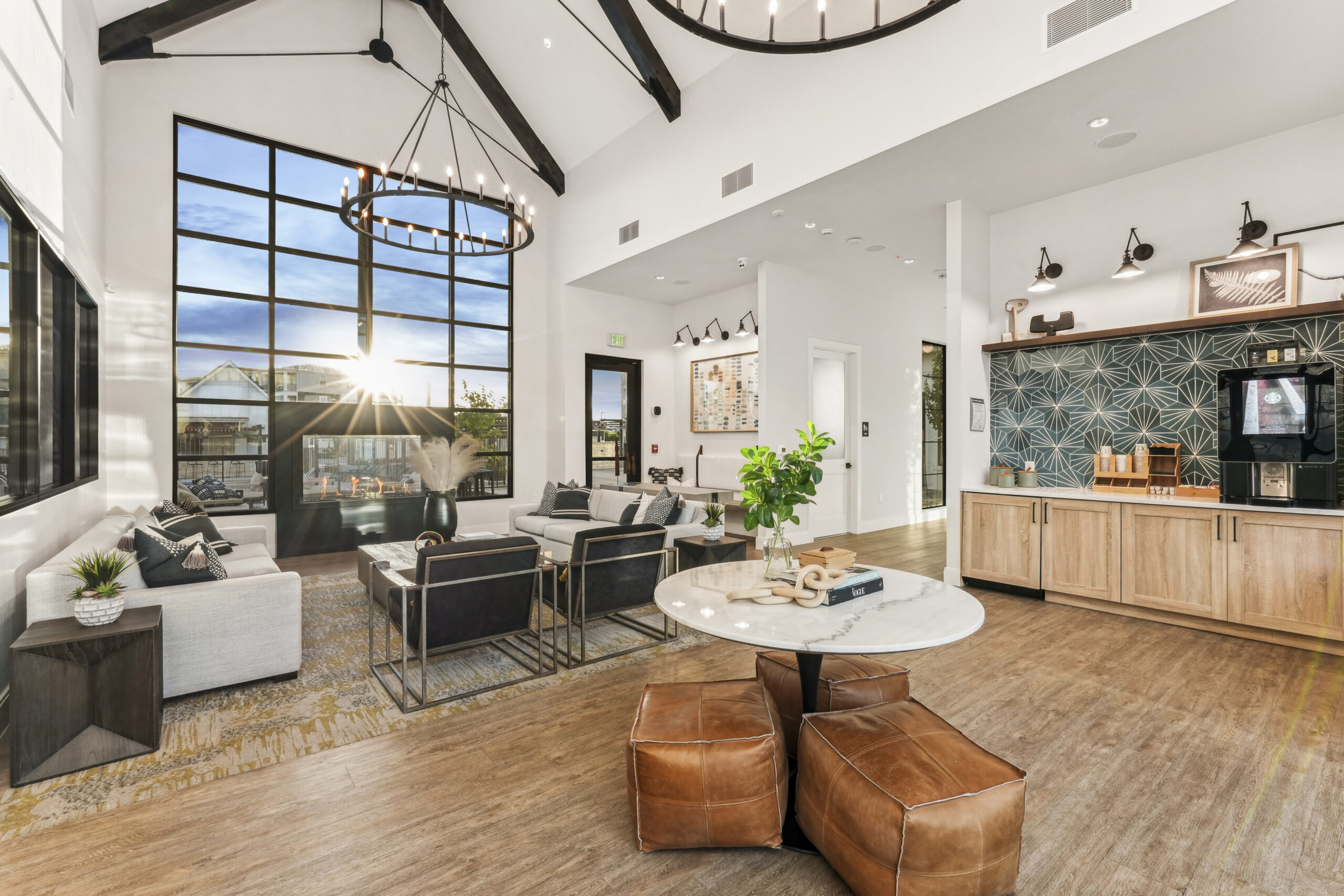 Clubhouse with elegant seating and decor, coffee bar, and large windows.