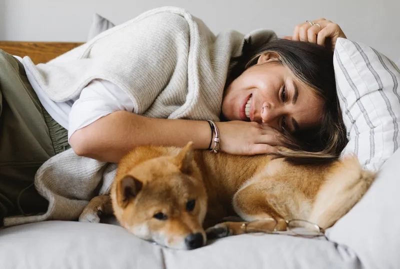 woman laying with her dog