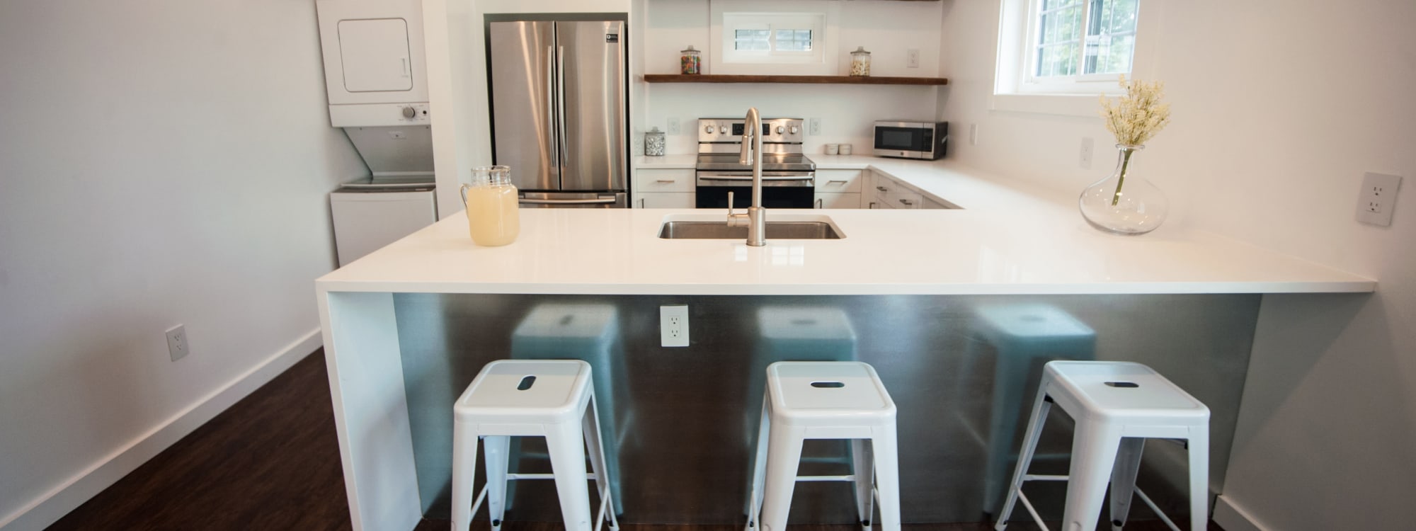 clean kitchen with refrigerator and gas range at Campus Prime in Syracuse, New York