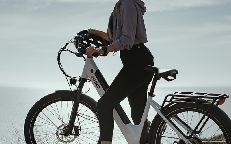 Woman on a bicycle overlooking the ocean